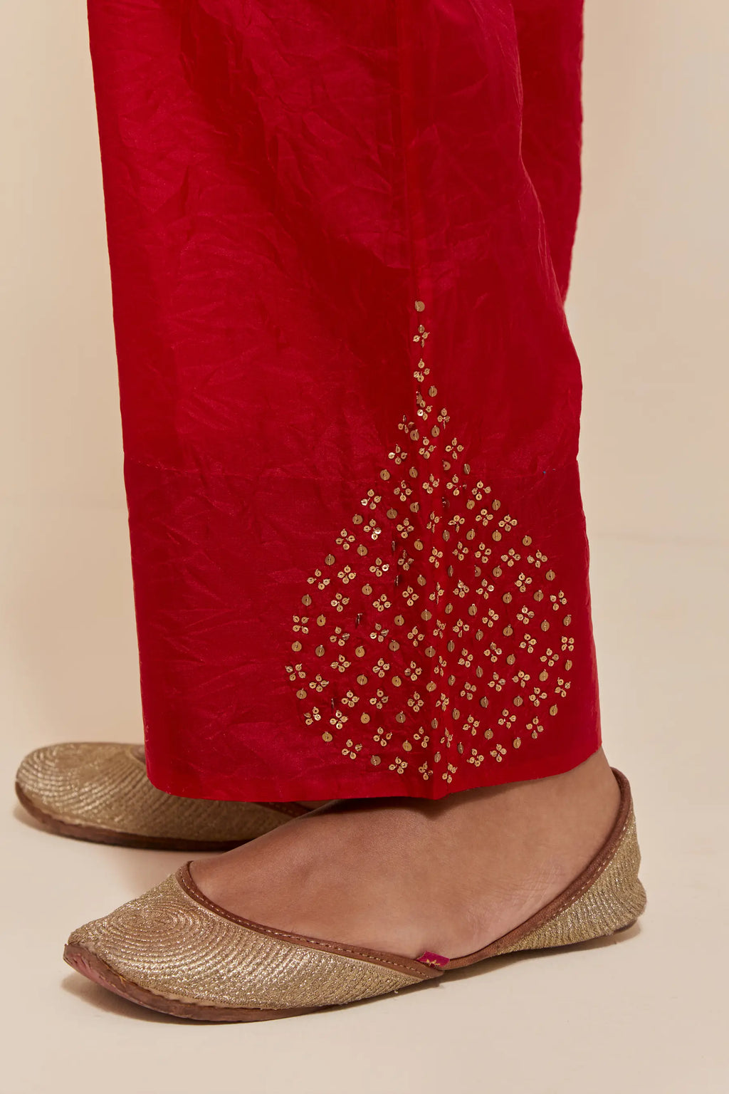 Red Silk pants with hand embroidered leaf motifs with delicate sequins work at hem.