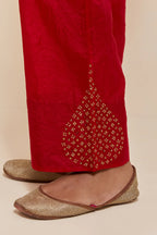 Red Silk pants with hand embroidered leaf motifs with delicate sequins work at hem.