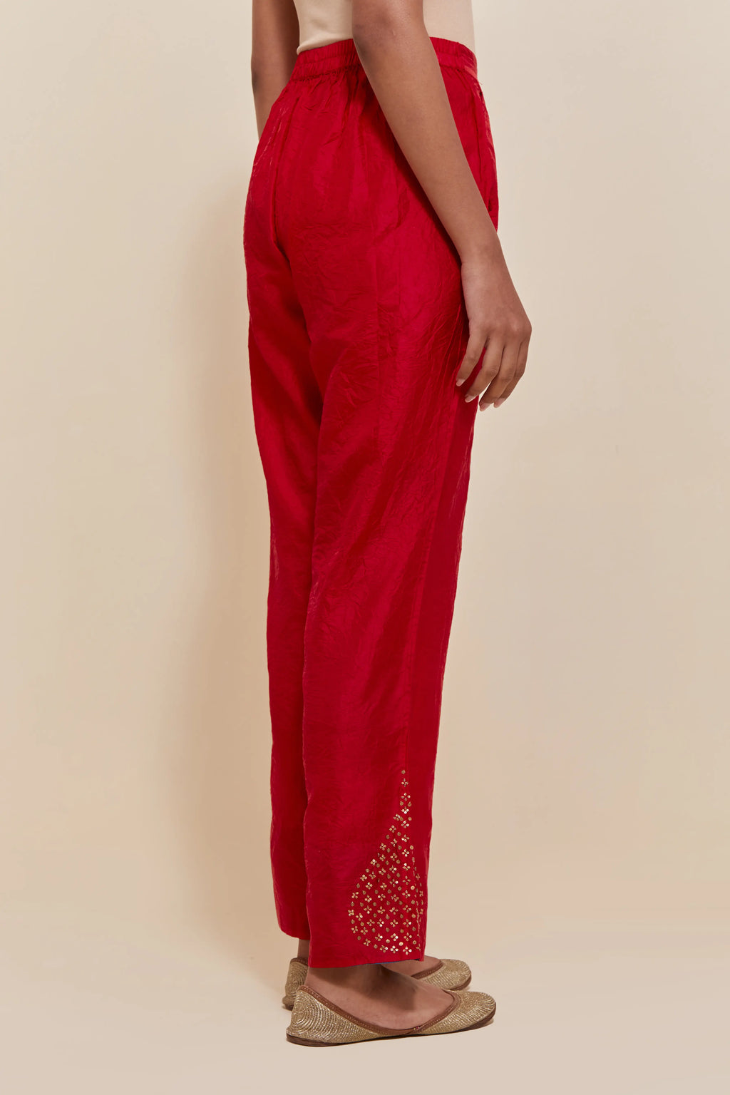 Red Silk pants with hand embroidered leaf motifs with delicate sequins work at hem.