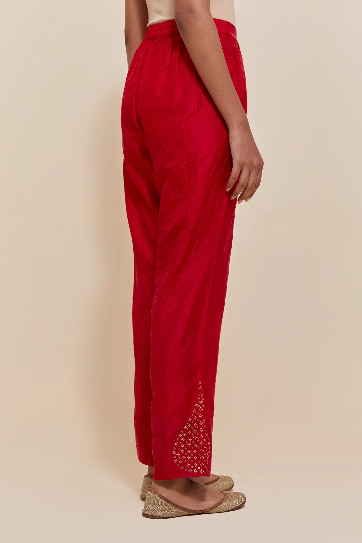 Red Silk pants with hand embroidered leaf motifs with delicate sequins work at hem.