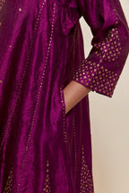 Purple silk short kalidar kurta set, with hand embroidered sequins at neck, hem and sleeve edges, highlighted with scattered gold sequins embellishments all-over.