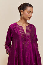 Purple silk short kalidar kurta set, with hand embroidered sequins at neck, hem and sleeve edges, highlighted with scattered gold sequins embellishments all-over.