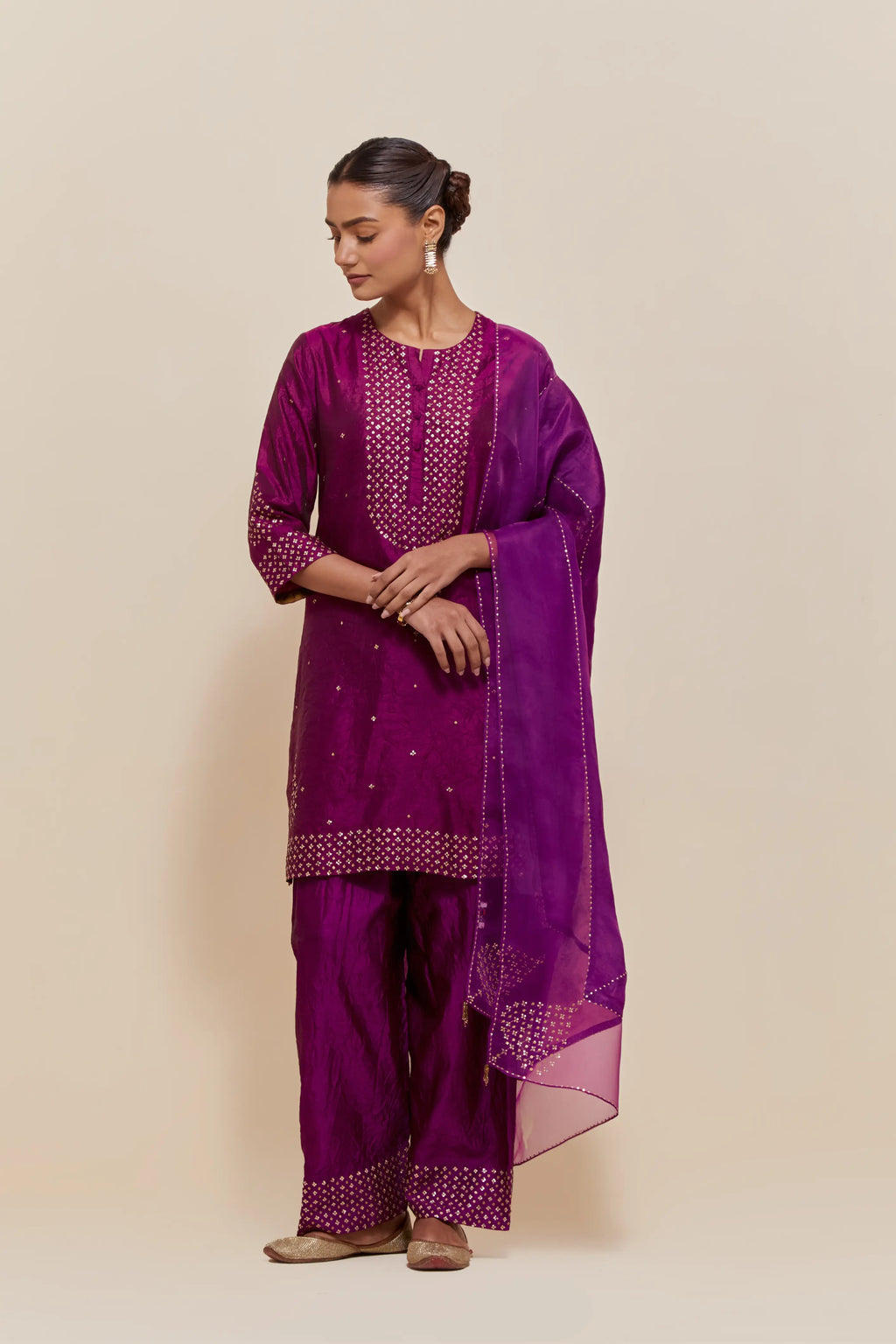 Purple silk dupatta with silk organza at the sides, highlighted with hand-embroidered gold sequins work.
