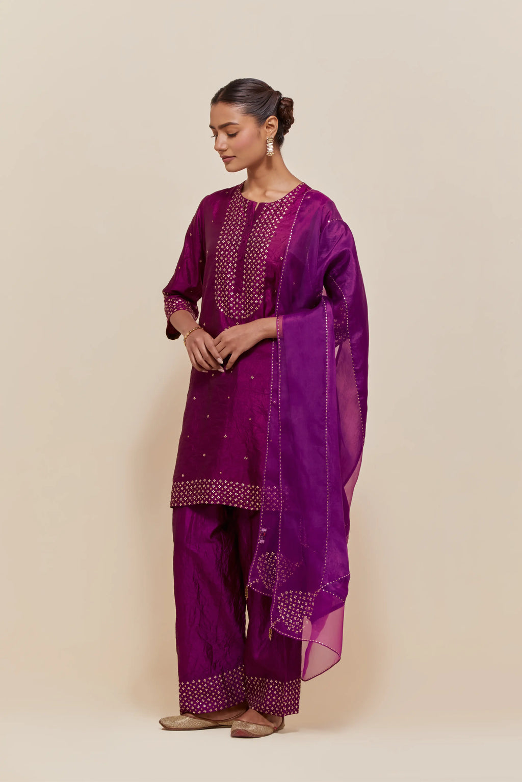 Purple silk dupatta with silk organza at the sides, highlighted with hand-embroidered gold sequins work.