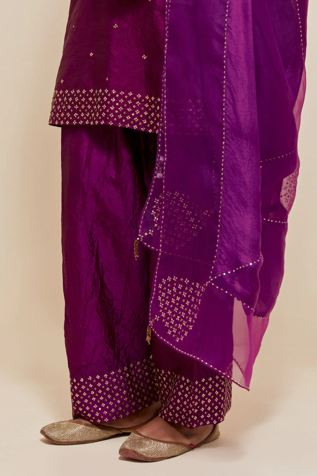 Purple silk dupatta with silk organza at the sides, highlighted with hand-embroidered gold sequins work.
