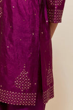 Purple silk straight short kurta set with hand-embroidered sequins at the neck, borders running along the hem and sleeve edges, and scattered gold sequins embellishments all-over.