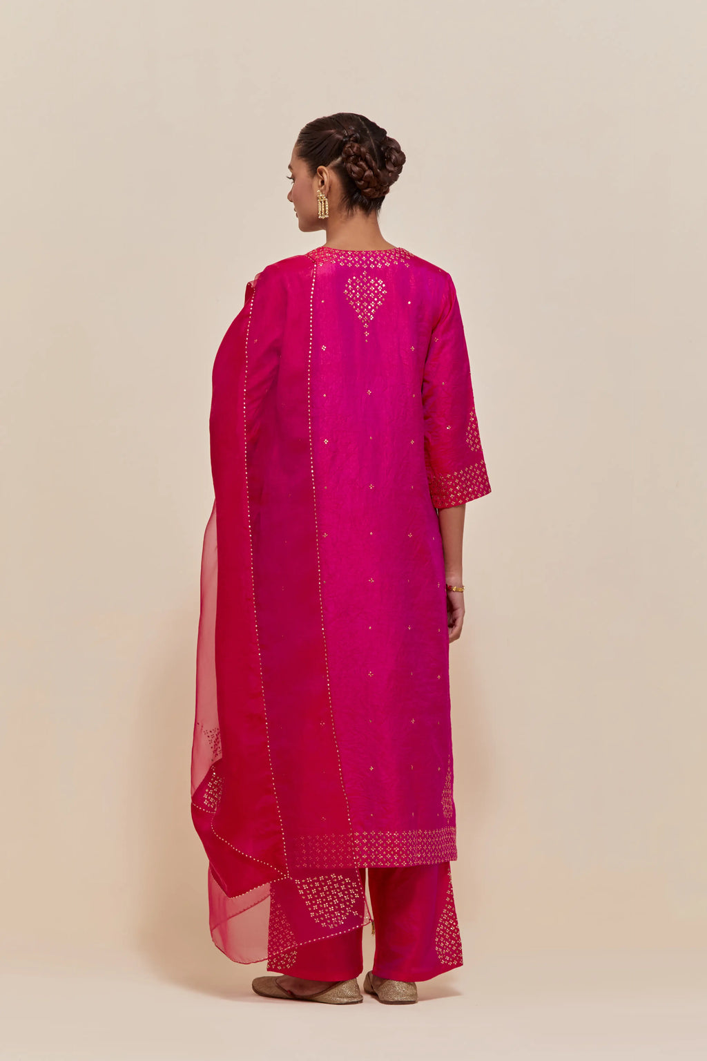 Fuchsia silk dupatta with silk organza at the sides, highlighted with hand-embroidered gold sequins work.