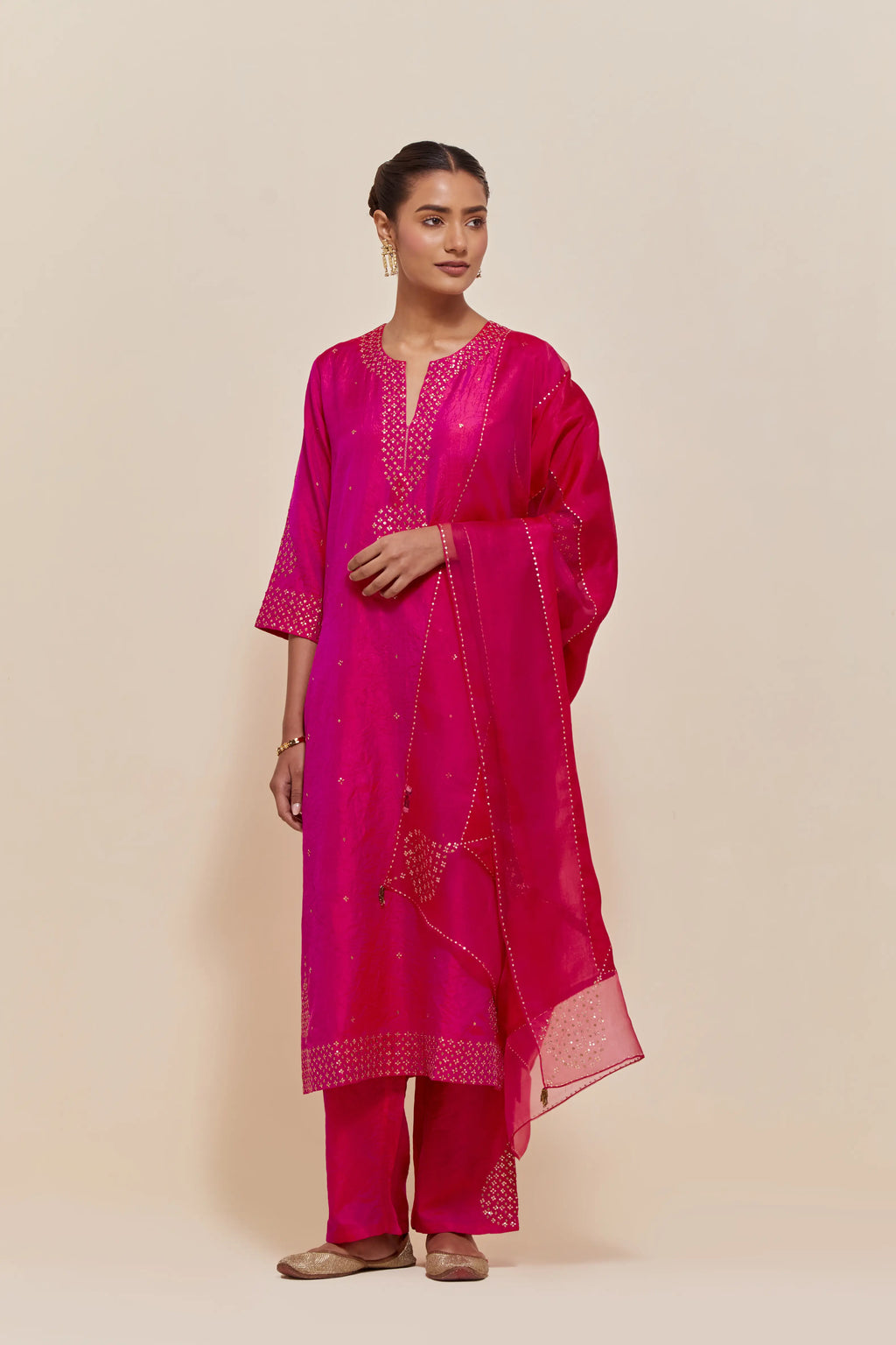 Fuchsia silk dupatta with silk organza at the sides, highlighted with hand-embroidered gold sequins work.