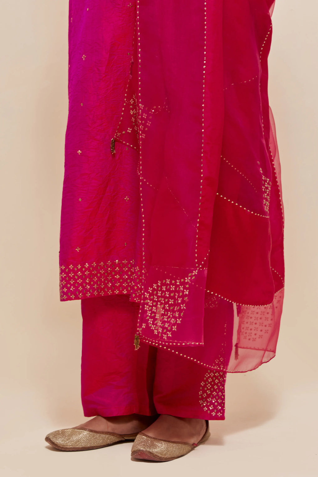 Fuchsia silk dupatta with silk organza at the sides, highlighted with hand-embroidered gold sequins work.