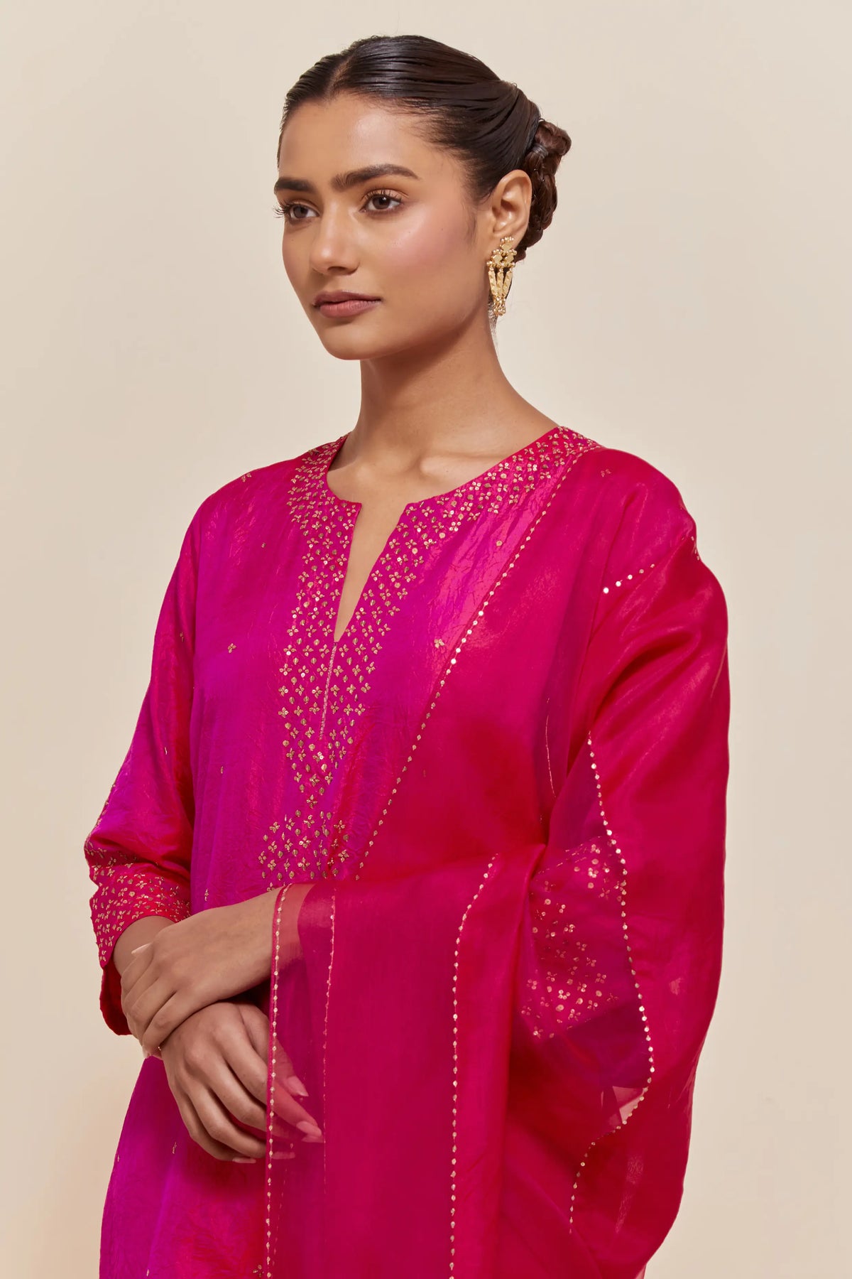 Fuchsia silk dupatta with silk organza at the sides, highlighted with hand-embroidered gold sequins work.