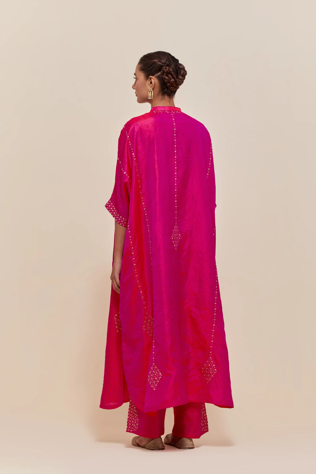 Fuchsia silk long kaftan with hand-embroidered sequins at the neck and diamond motifs along the sides, paired with Fuchsia Silk pants with hand embroidered leaf motifs with delicate sequins work at hem.