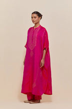 Fuchsia silk long kaftan with hand-embroidered sequins at the neck and diamond motifs along the sides, paired with Fuchsia Silk pants with hand embroidered leaf motifs with delicate sequins work at hem.