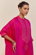 Fuchsia silk long kaftan with hand-embroidered sequins at the neck and diamond motifs along the sides, paired with Fuchsia Silk pants with hand embroidered leaf motifs with delicate sequins work at hem.