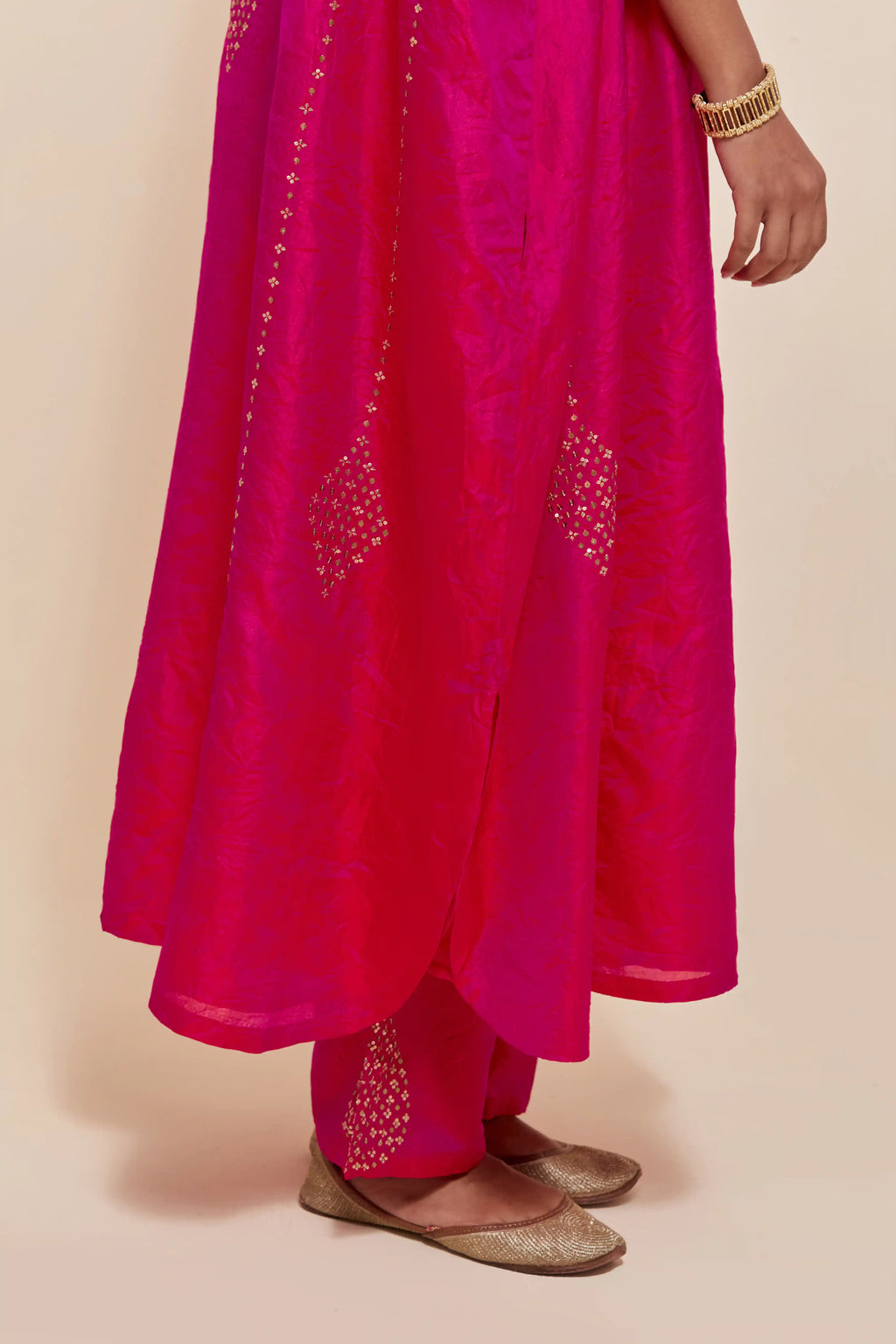 Fuchsia silk long kaftan with hand-embroidered sequins at the neck and diamond motifs along the sides, paired with Fuchsia Silk pants with hand embroidered leaf motifs with delicate sequins work at hem.