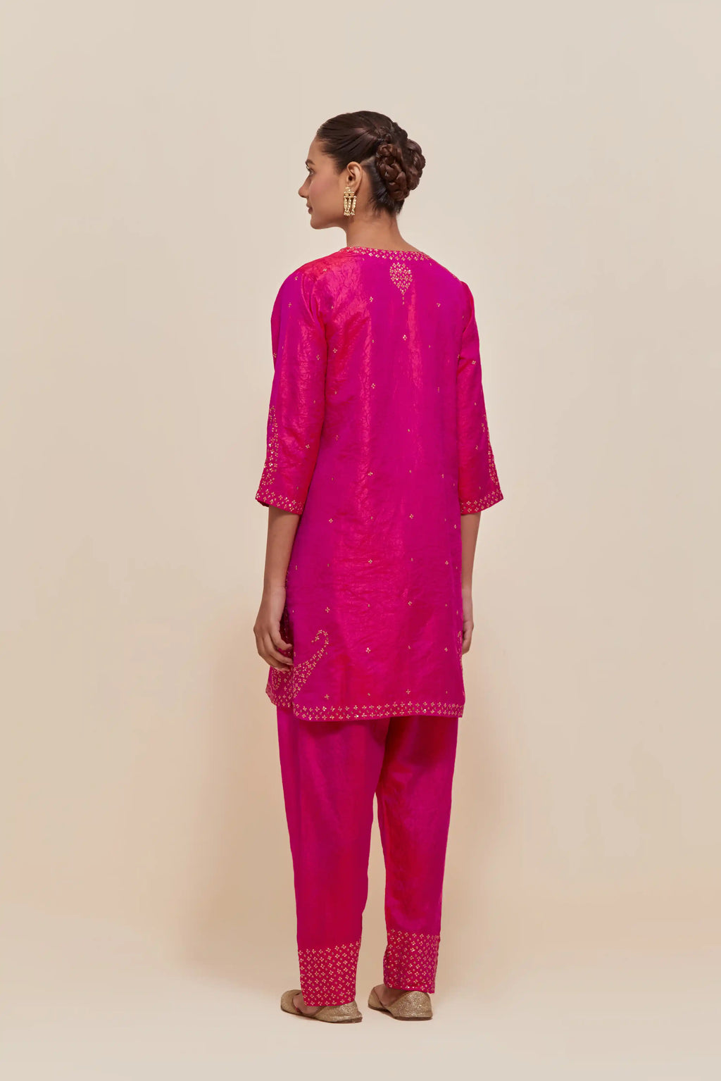 Fuchsia silk straight short kurta set with hand-embroidered paisley motifs with delicate sequins work at neck, hem, and sleeves, with narrow borders along the edges.