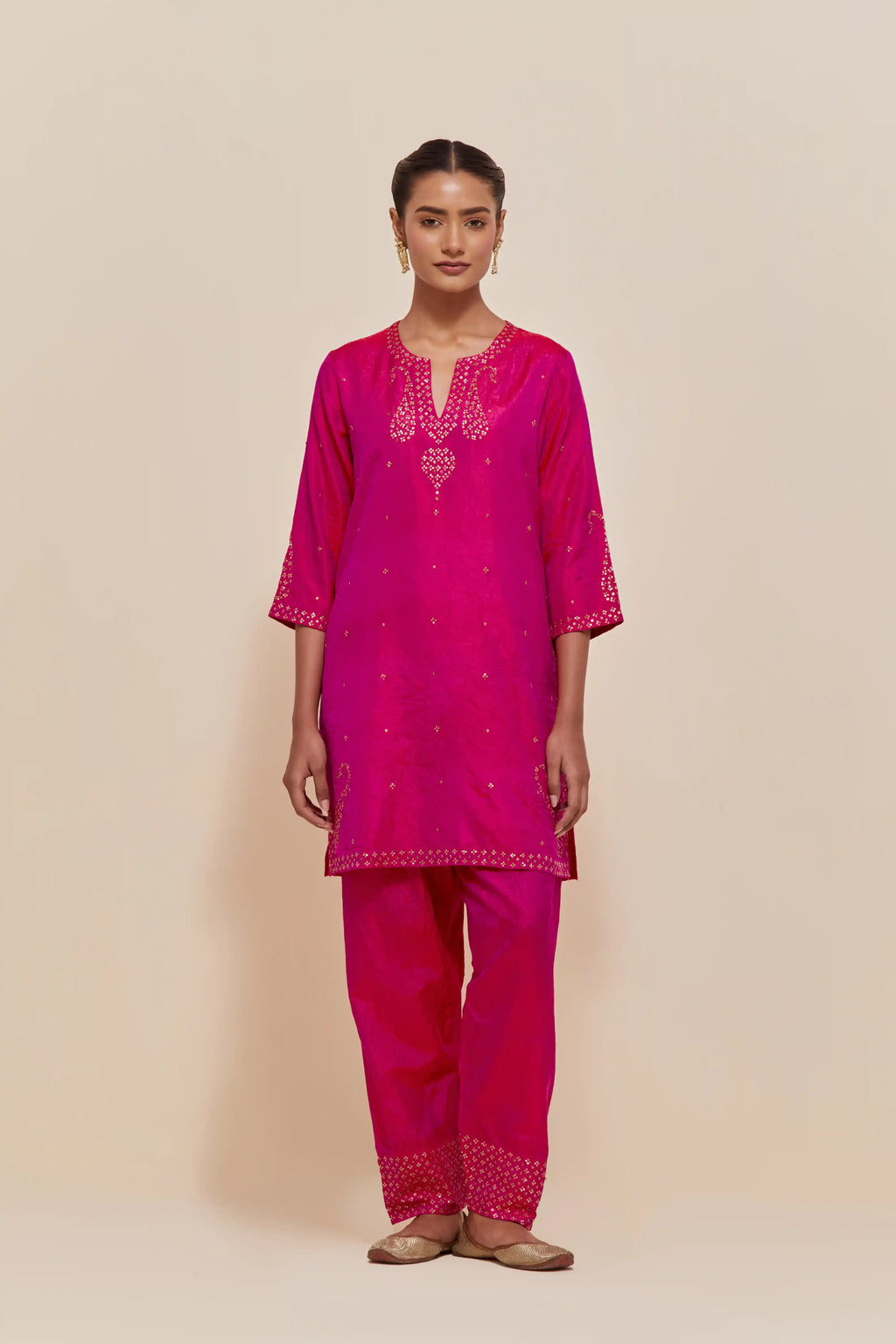 Fuchsia silk straight short kurta set with hand-embroidered paisley motifs with delicate sequins work at neck, hem, and sleeves, with narrow borders along the edges.