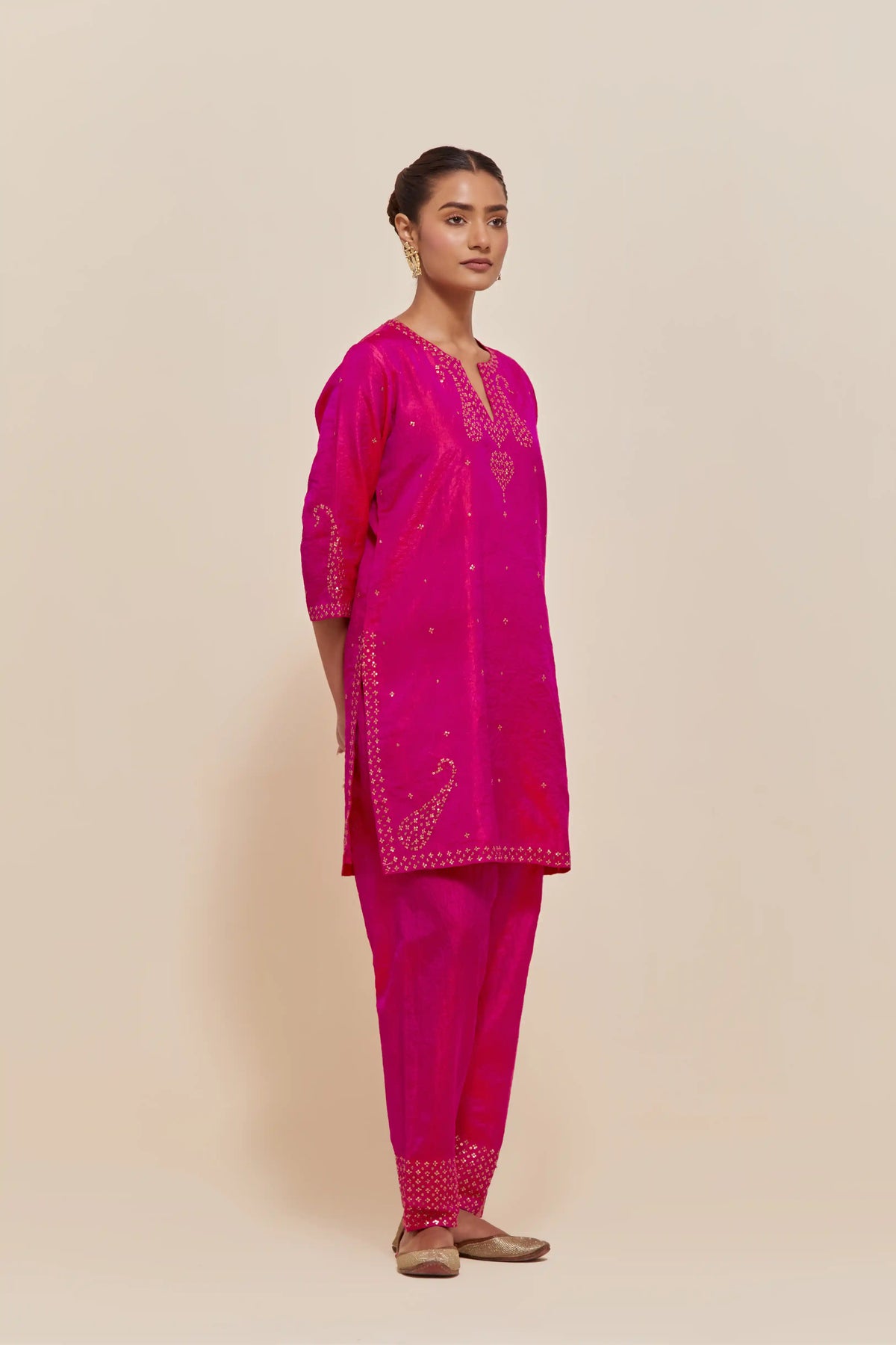Fuchsia silk straight short kurta set with hand-embroidered paisley motifs with delicate sequins work at neck, hem, and sleeves, with narrow borders along the edges.