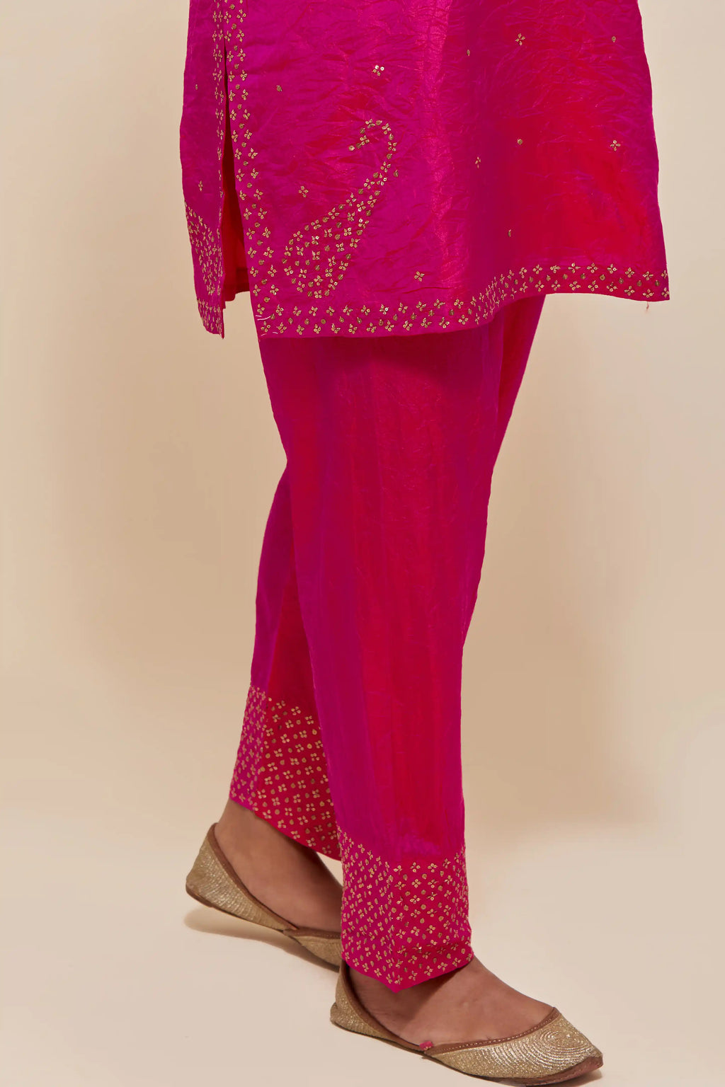 Fuchsia silk straight short kurta set with hand-embroidered paisley motifs with delicate sequins work at neck, hem, and sleeves, with narrow borders along the edges.