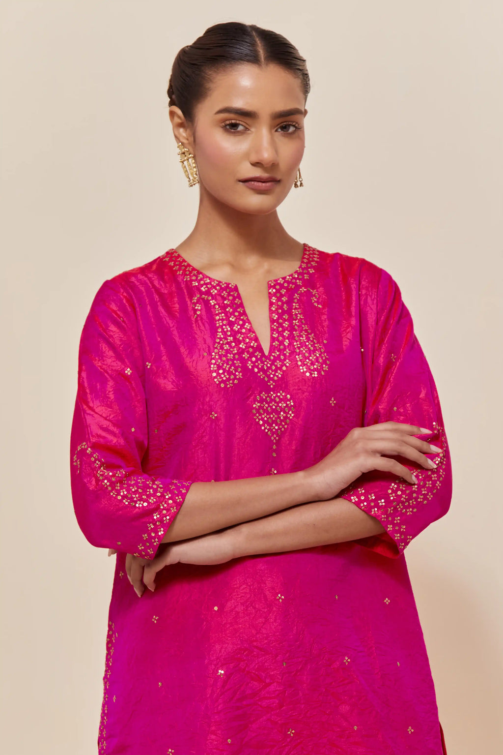 Fuchsia silk straight short kurta set with hand-embroidered paisley motifs with delicate sequins work at neck, hem, and sleeves, with narrow borders along the edges.