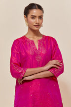 Fuchsia silk straight short kurta set with hand-embroidered paisley motifs with delicate sequins work at neck, hem, and sleeves, with narrow borders along the edges.
