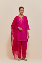 Fuchsia silk straight short kurta set with hand-embroidered paisley motifs with delicate sequins work at neck, hem, and sleeves, with narrow borders along the edges.