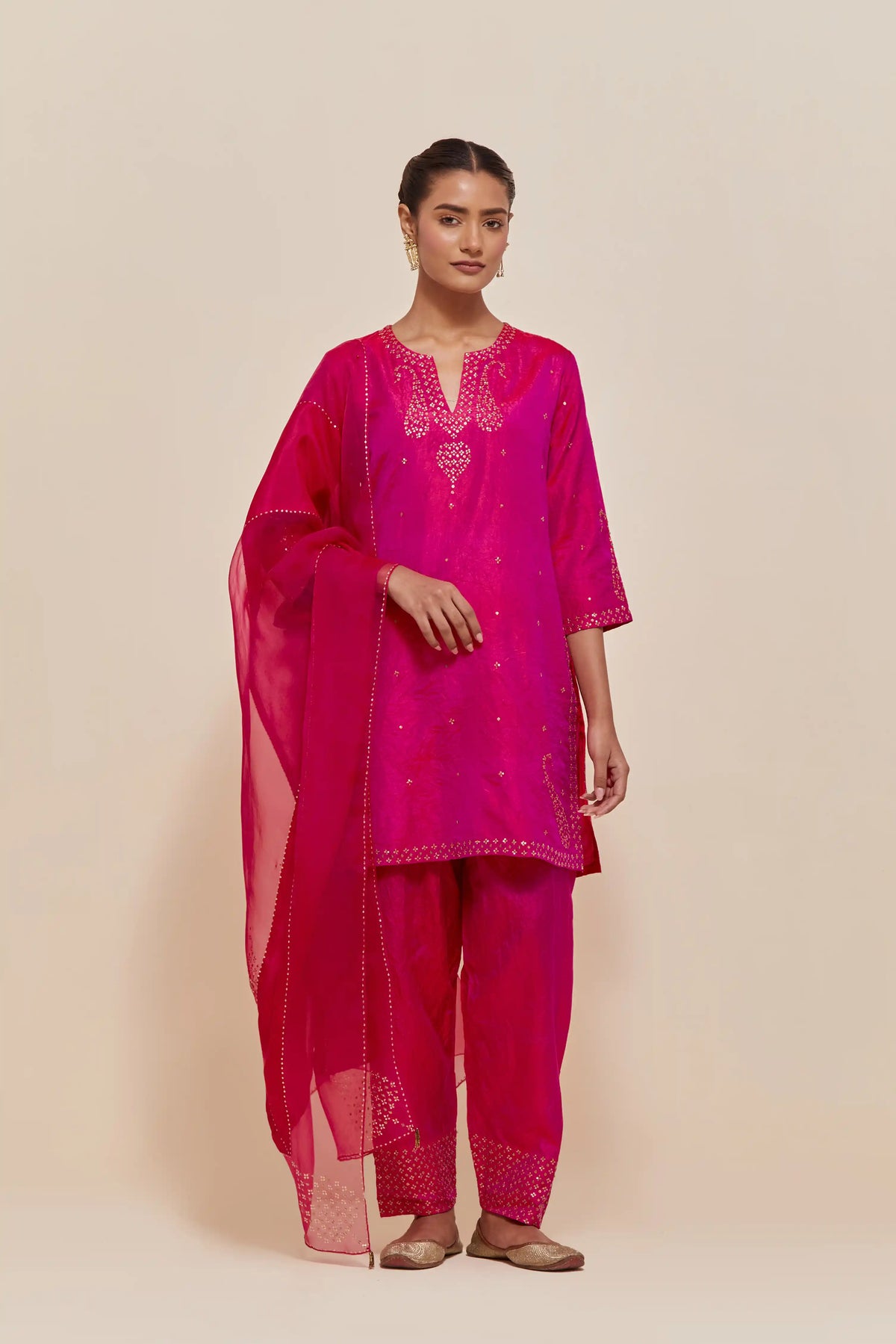Fuchsia silk straight short kurta set with hand-embroidered paisley motifs with delicate sequins work at neck, hem, and sleeves, with narrow borders along the edges.