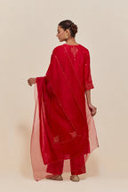 Red silk dupatta with silk organza at the sides, highlighted with hand-embroidered gold sequins work.