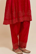 Red silk short kalidar kurta set, with hand embroidered sequins at neck, hem and sleeve edges, highlighted with scattered gold sequins embellishments all-over.