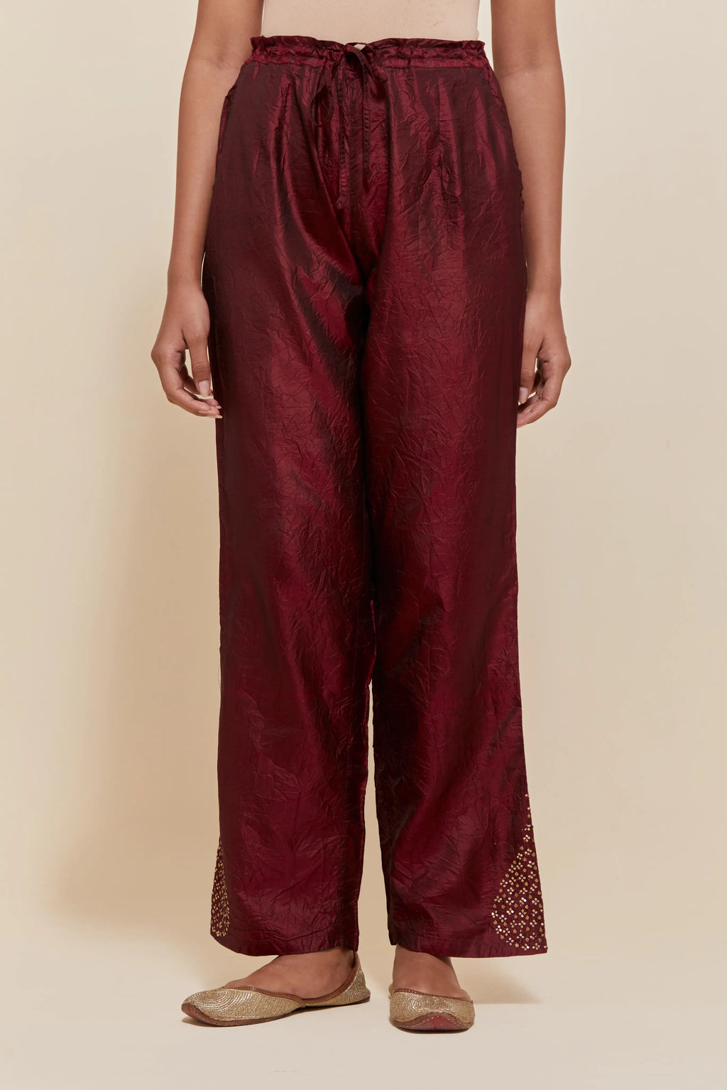 Maroon Silk pants with hand embroidered leaf motifs with delicate sequins work at hem.