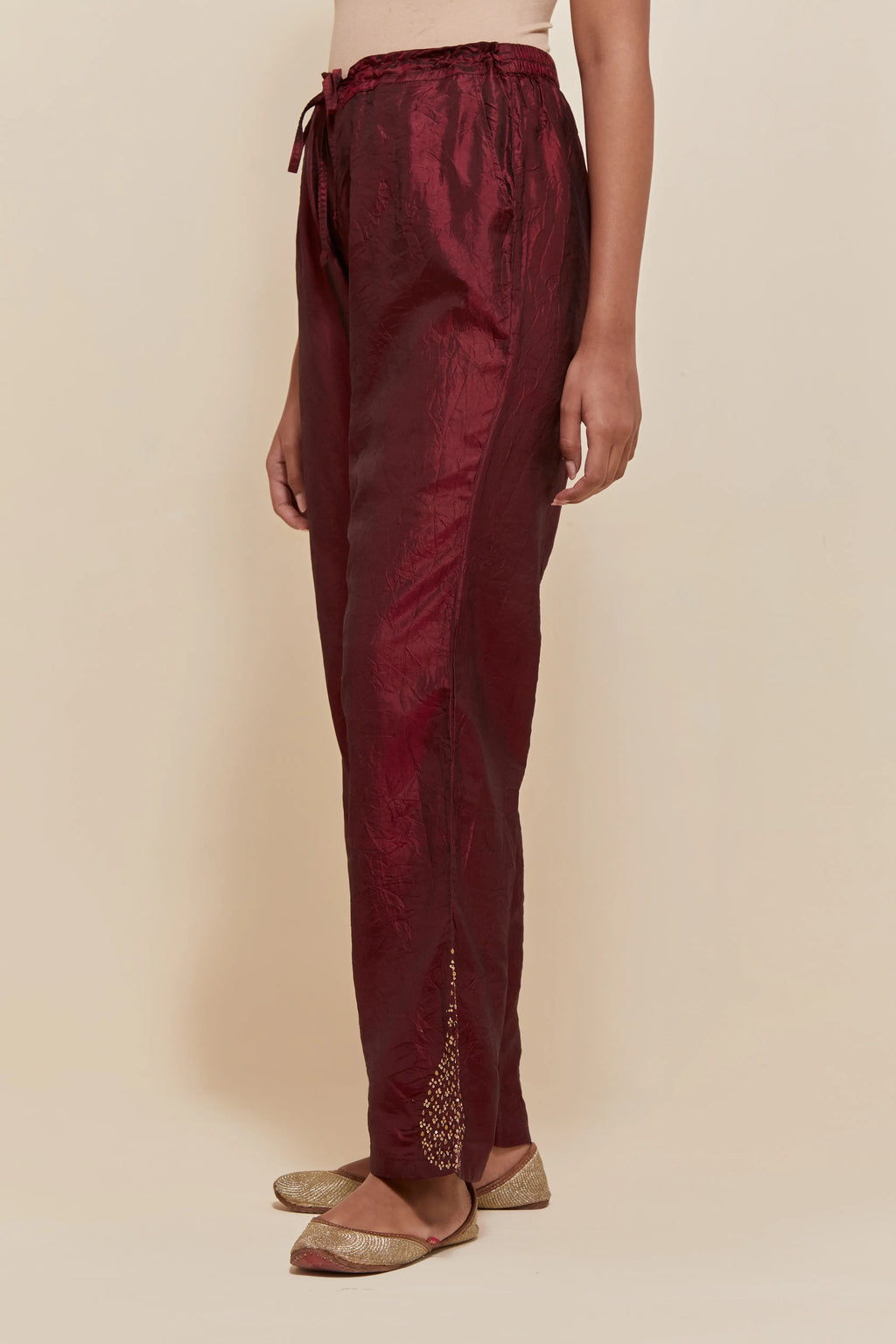 Maroon Silk pants with hand embroidered leaf motifs with delicate sequins work at hem.