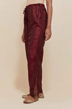 Maroon Silk pants with hand embroidered leaf motifs with delicate sequins work at hem.