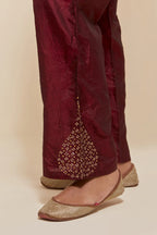 Maroon Silk pants with hand embroidered leaf motifs with delicate sequins work at hem.