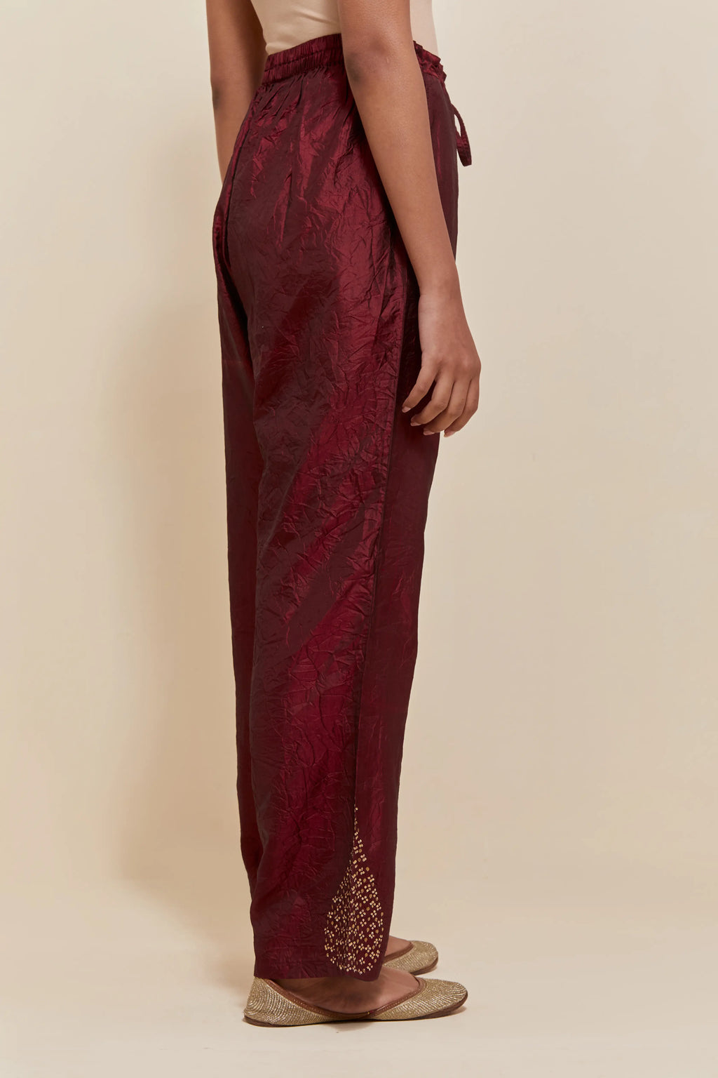 Maroon Silk pants with hand embroidered leaf motifs with delicate sequins work at hem.