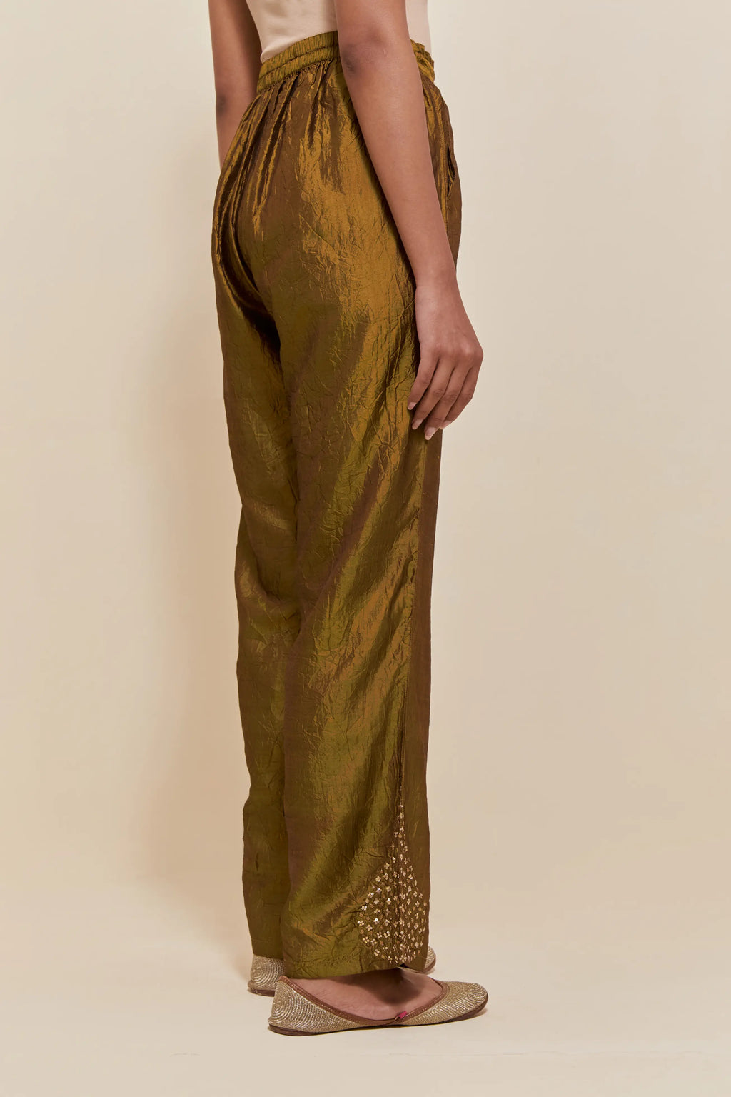 Olive Silk pants with hand embroidered leaf motifs with delicate sequins work at hem.