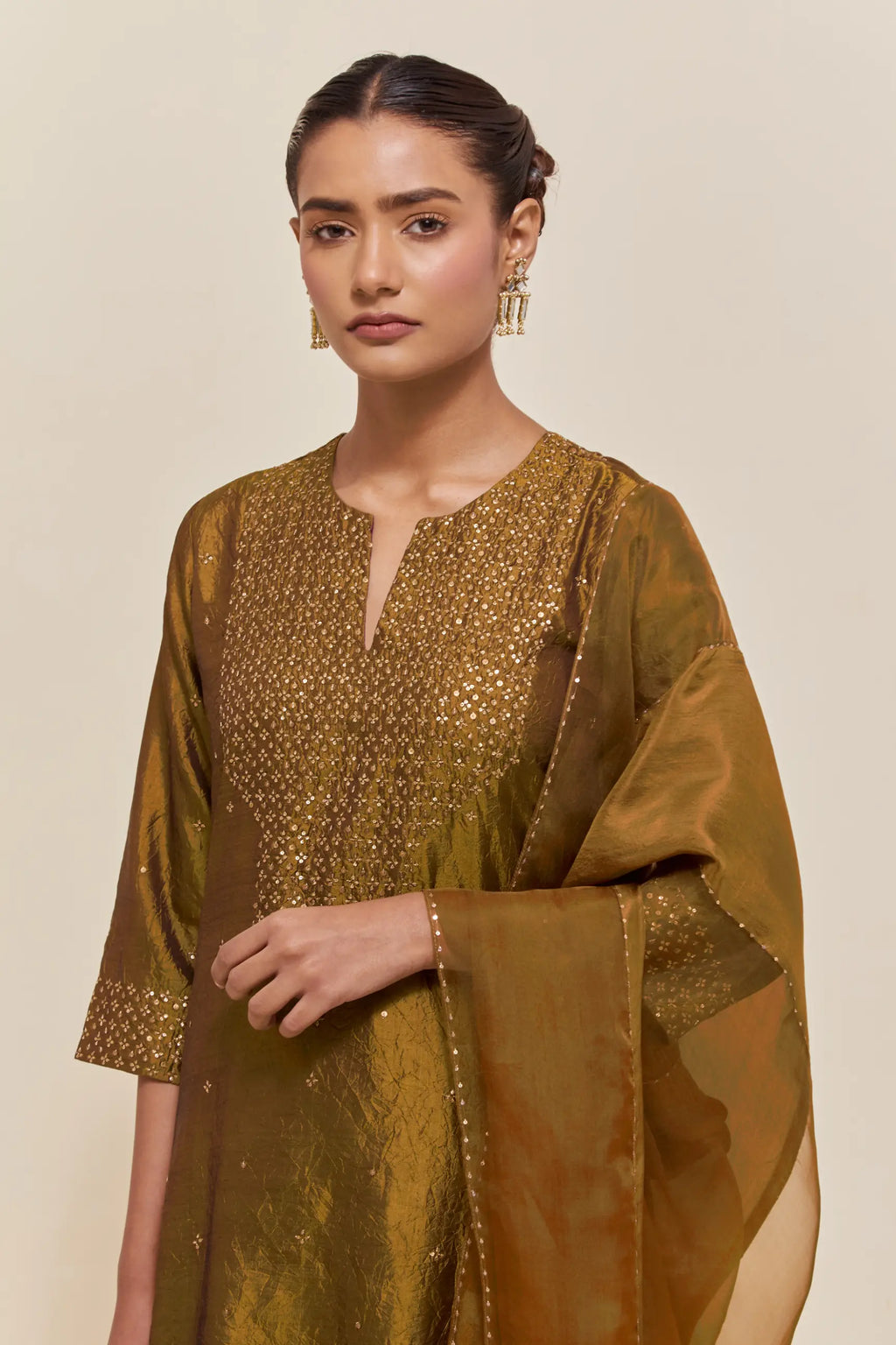 Olive silk dupatta with silk organza at the sides, highlighted with hand-embroidered gold sequins work.