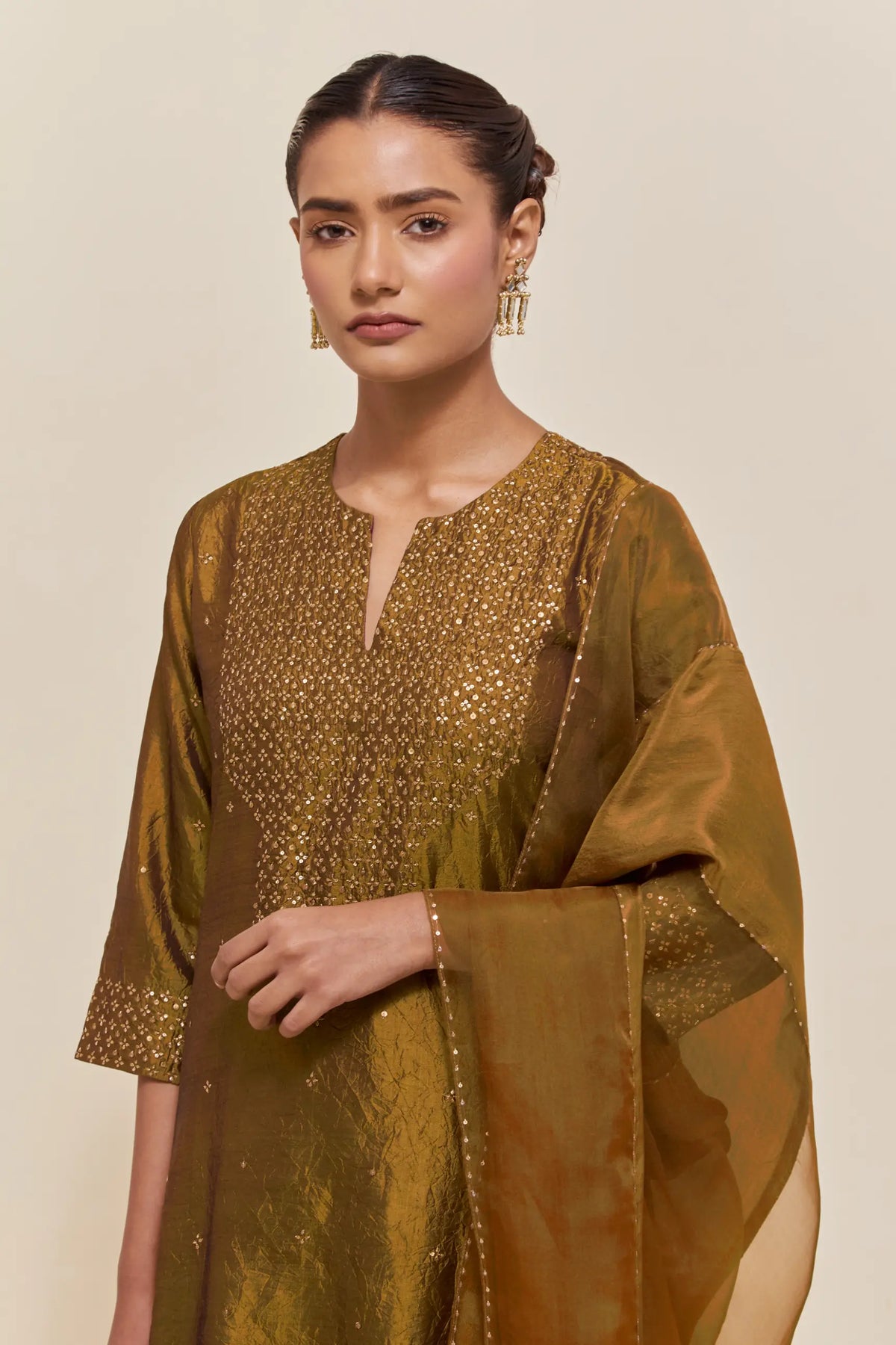 Olive silk dupatta with silk organza at the sides, highlighted with hand-embroidered gold sequins work.