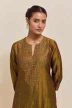 Olive silk straight kurta set with hand-embroidered sequins at the neck, hem and sleeves, highlighted with scattered gold sequins embellishments all-over.
