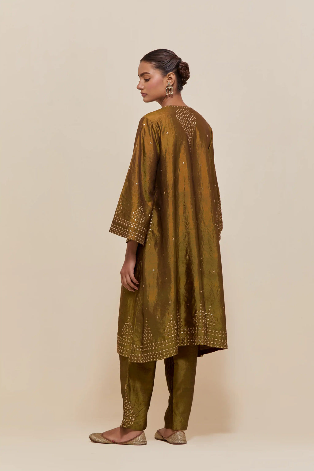 Olive silk A-line short kurta set with hand-embroidered sequins at the neck, borders running along the hem and sleeve edges, and scattered gold sequin embellishments all-over.