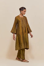 Olive silk A-line short kurta set with hand-embroidered sequins at the neck, borders running along the hem and sleeve edges, and scattered gold sequin embellishments all-over.