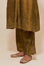 Olive silk A-line short kurta set with hand-embroidered sequins at the neck, borders running along the hem and sleeve edges, and scattered gold sequin embellishments all-over.
