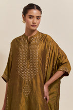 Olive silk long kaftan with hand-embroidered sequins at the neck and diamond motifs along the sides, paired with olive Silk pants with hand embroidered leaf motifs with delicate sequins work at hem.