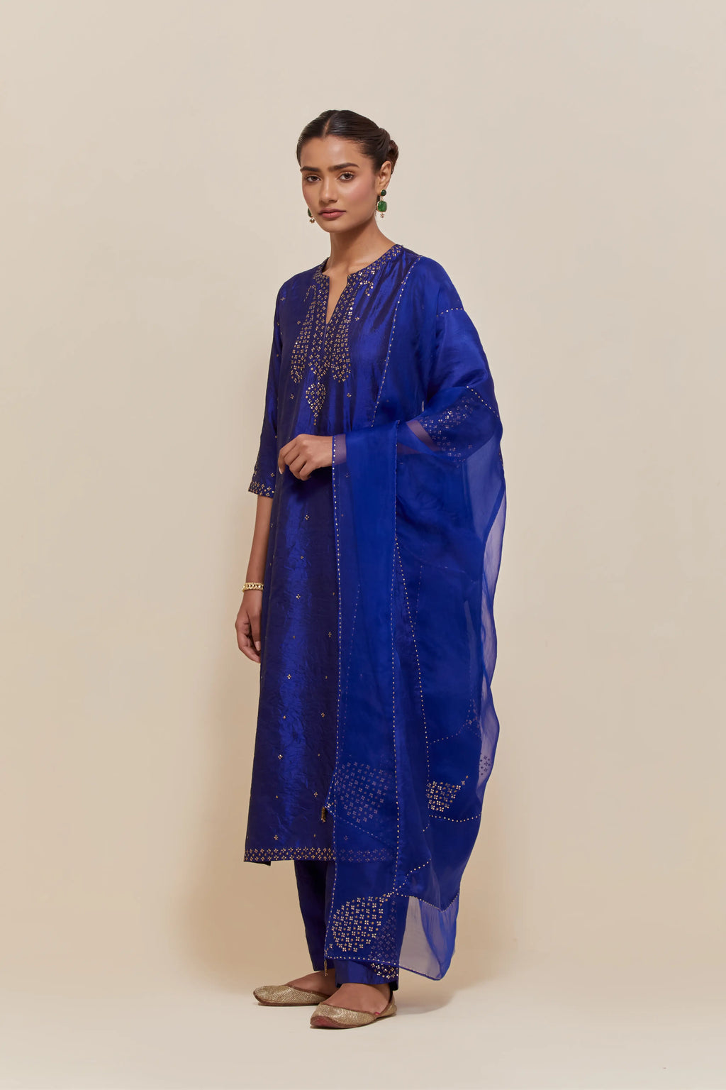 Blue silk dupatta with silk organza at the sides, highlighted with hand-embroidered gold sequins work.