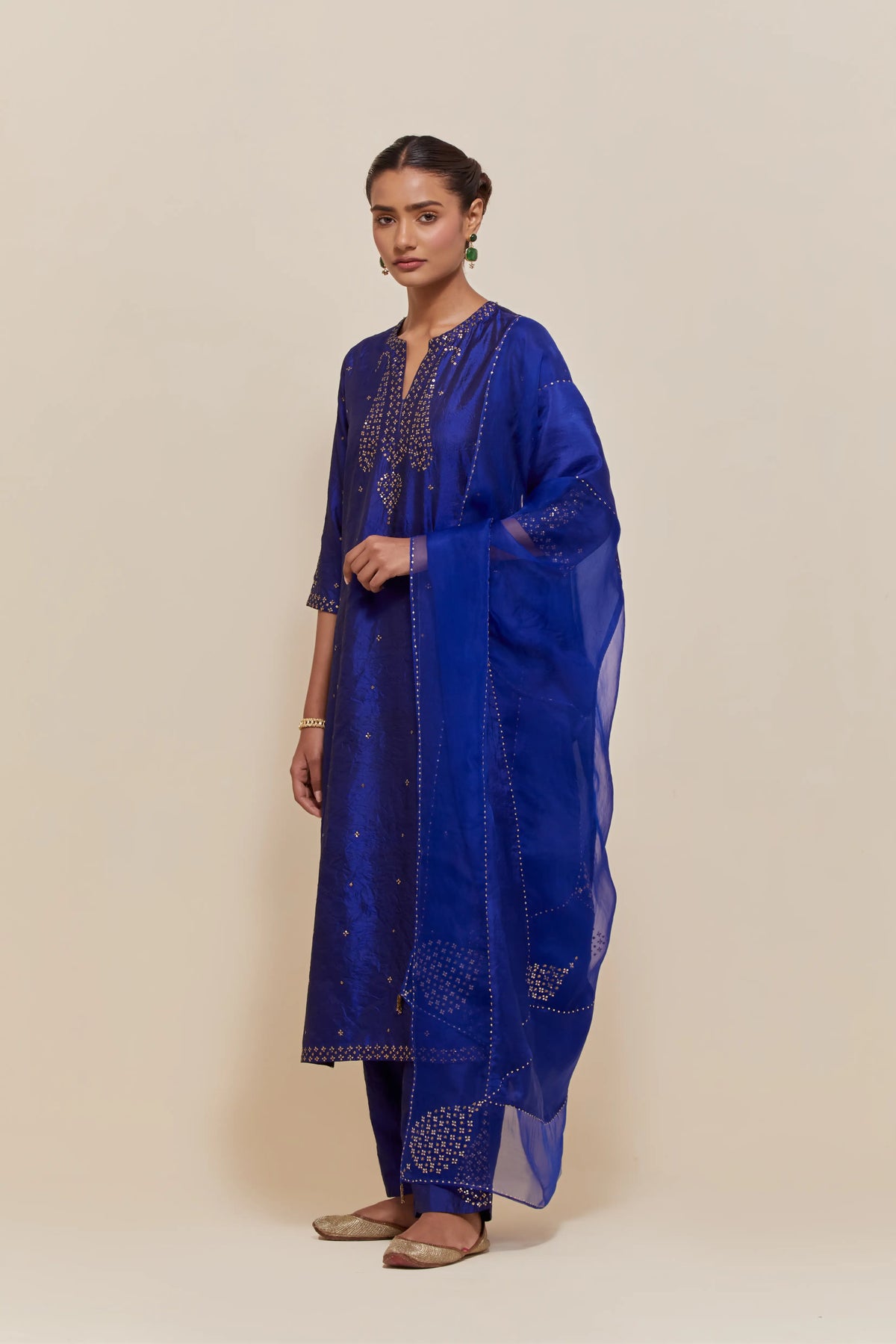 Blue silk dupatta with silk organza at the sides, highlighted with hand-embroidered gold sequins work.