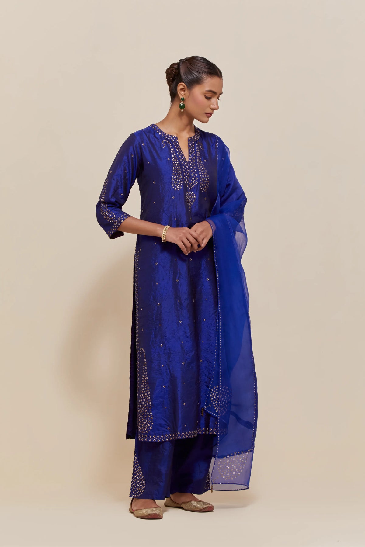 Blue silk dupatta with silk organza at the sides, highlighted with hand-embroidered gold sequins work.