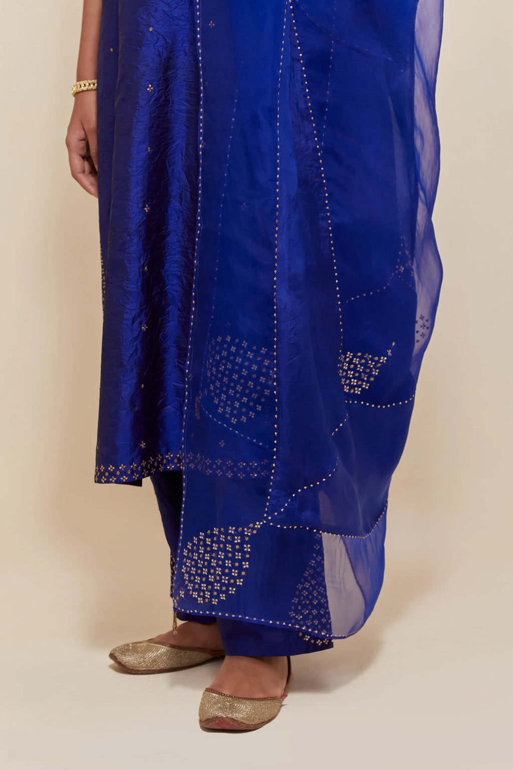 Blue silk dupatta with silk organza at the sides, highlighted with hand-embroidered gold sequins work.