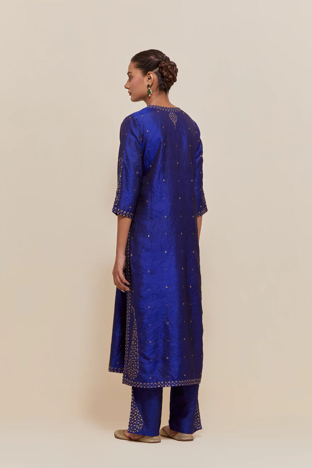 Blue silk straight kurta set with hand-embroidered paisley motifs with delicate gold sequins work at neck, hem, and sleeves, with narrow borders along the edges.