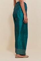 Teal green silk farshi salwar with hand-embroidered gold sequins work in a broad border at the hem.