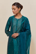 Teal green silk straight short kurta set with hand-embroidered sequins at the neck, borders running along the hem and sleeve edges, and scattered gold sequins embellishments all-over.