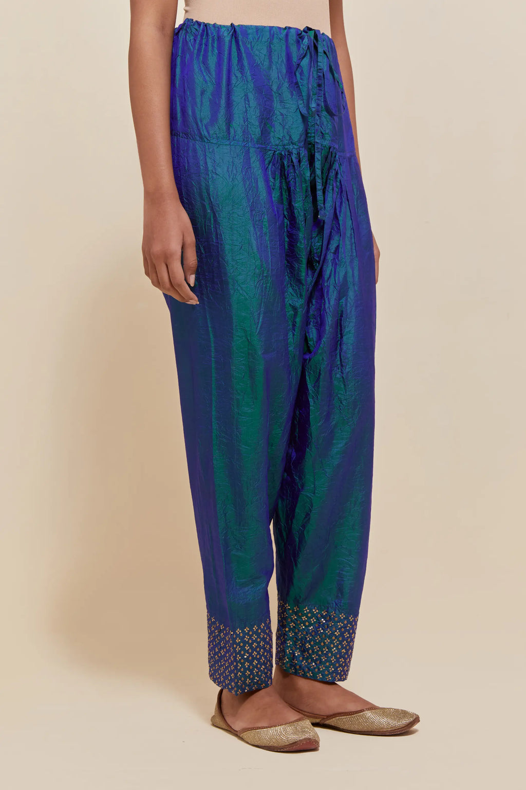 Teal blue silk salwar with hand-embroidered gold sequin work in a broad border at the hem.
