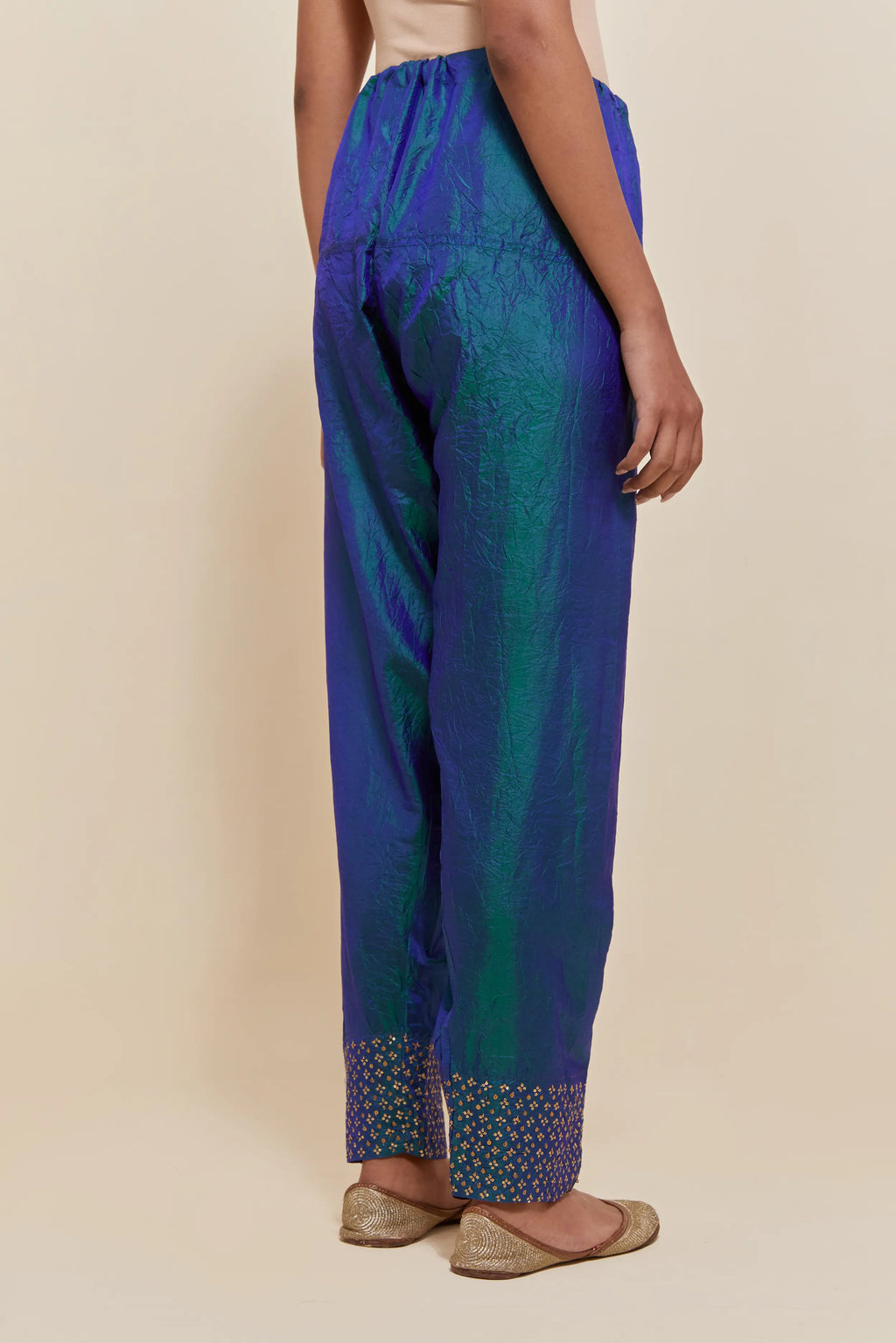 Teal blue silk salwar with hand-embroidered gold sequin work in a broad border at the hem.